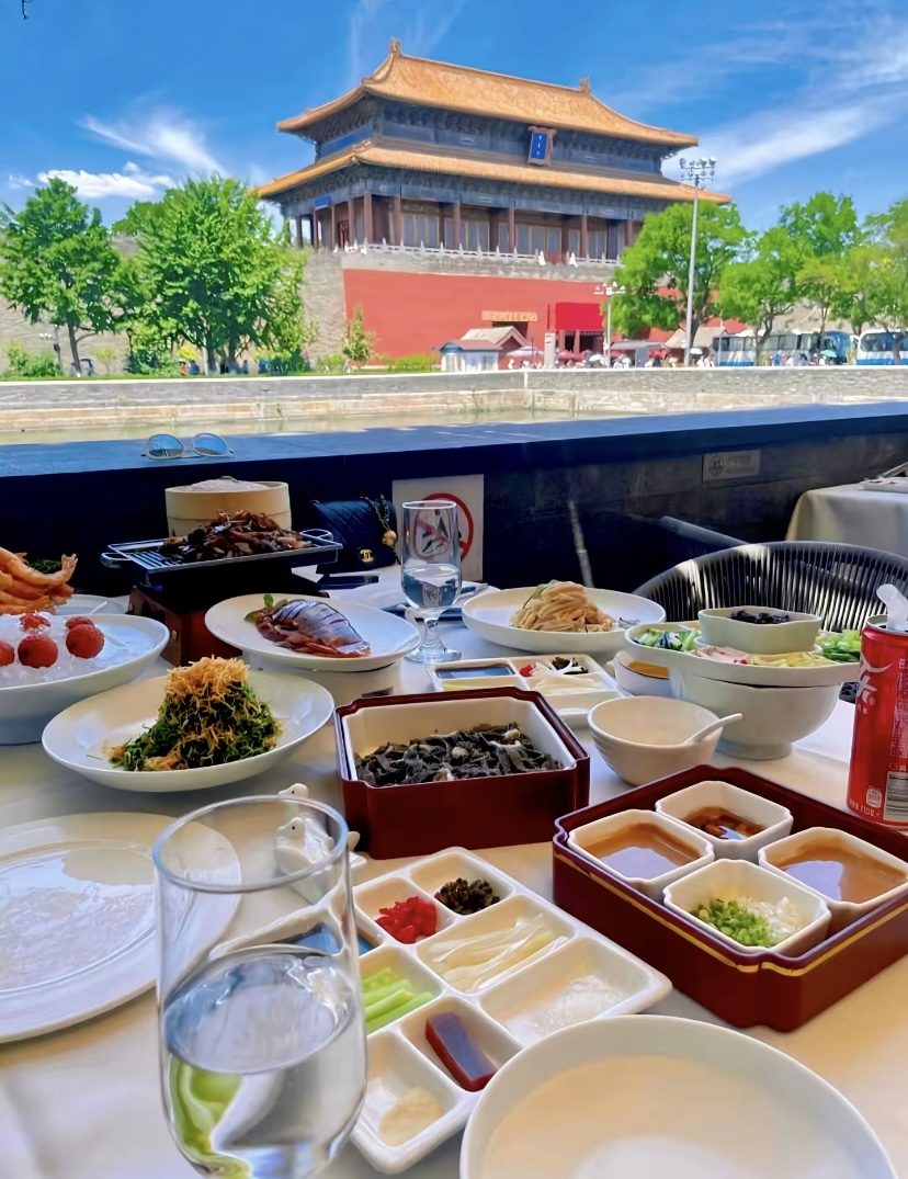 Roast duck lunch on a terrace overlooking the Forbidden City gate tower and moat in Beijing