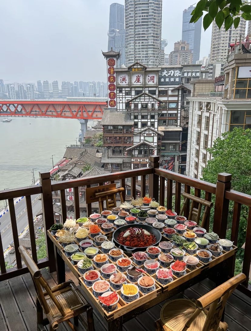 Chongqing hotpot table with fresh ingredients on a terrace overlooking Hongyadong