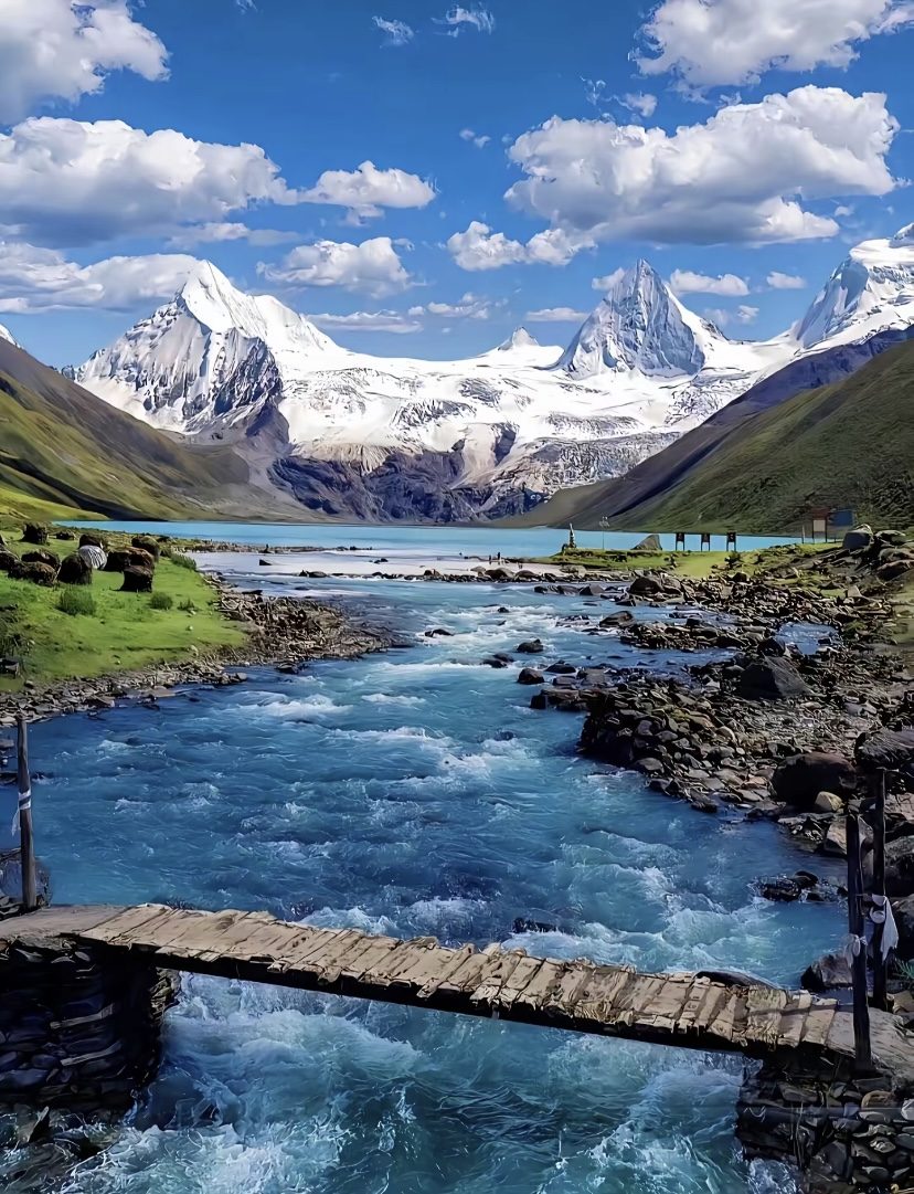 Turquoise glacial river below snow peaks in western Sichuan
