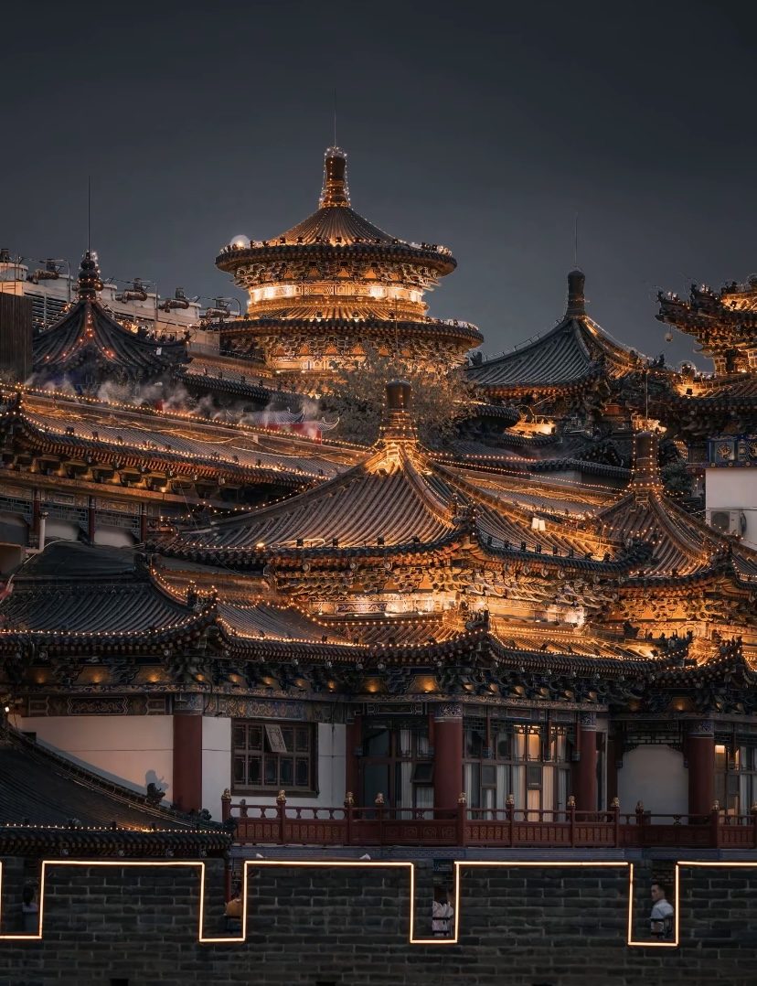 Traditional Chinese temple roofs lit up at night in Xi'an