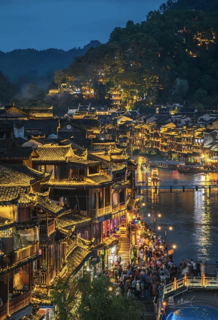 Fenghuang Ancient Town lit up at night along the Tuojiang River