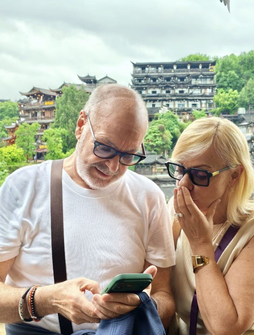 An older couple at the Furong ancient-town waterfall on a senior-friendly private China tour