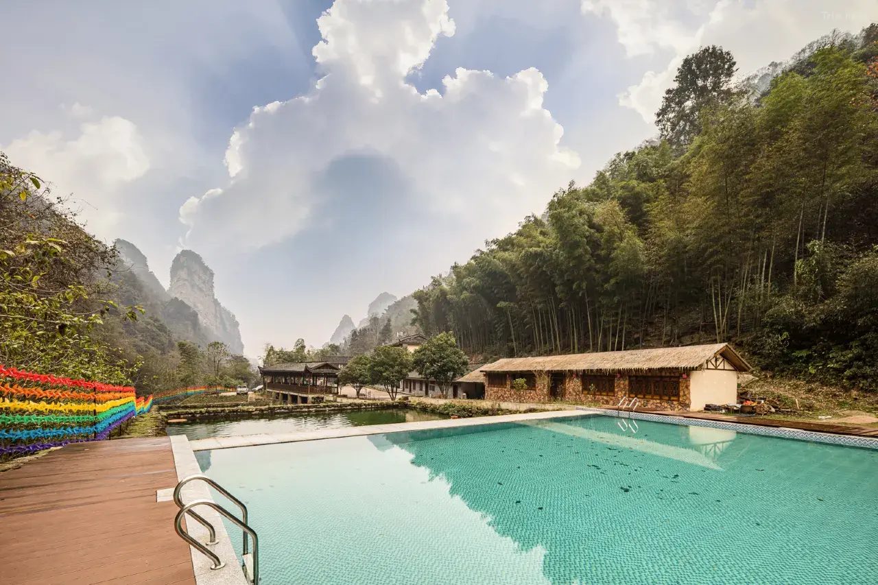 Outdoor pool with Zhangjiajie karst-mountain backdrop at Baofeng Xianju