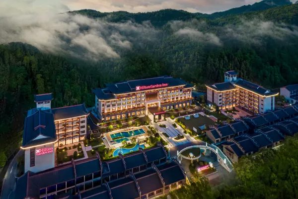 Hilton Garden Inn Zhangjiajie resort at twilight among misty mountains