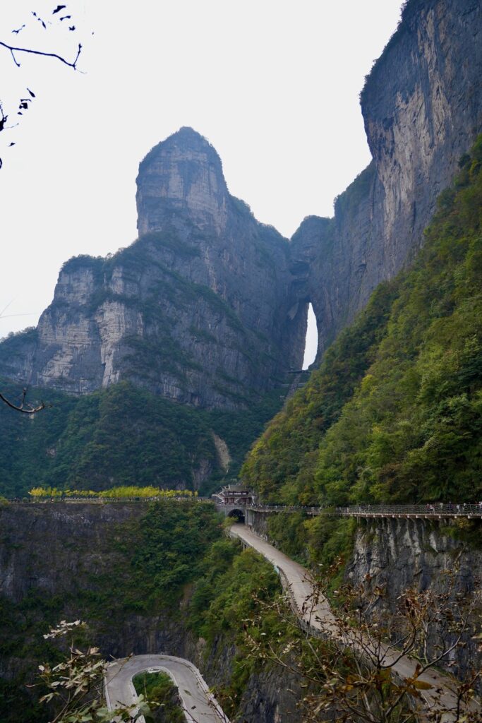 Tianmen Cave high above the tunnel gate and a hairpin of the 99-bend road, Tianmen Mountain