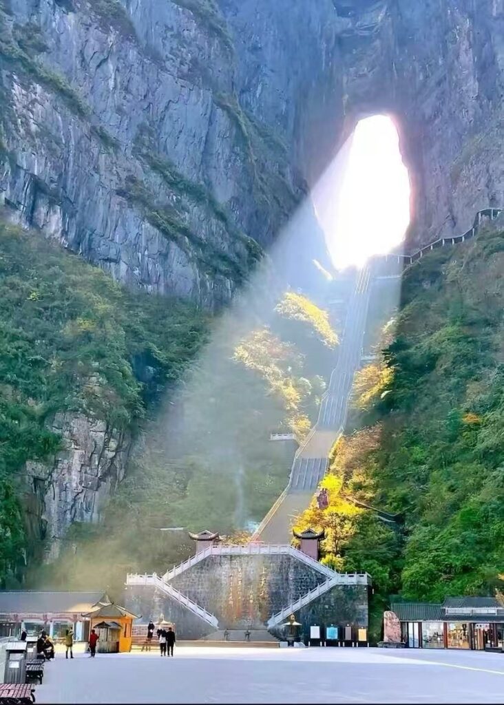 Sunlight streaming through Tianmen Cave onto the 999 steps and the cave square, Tianmen Mountain, Zhangjiajie