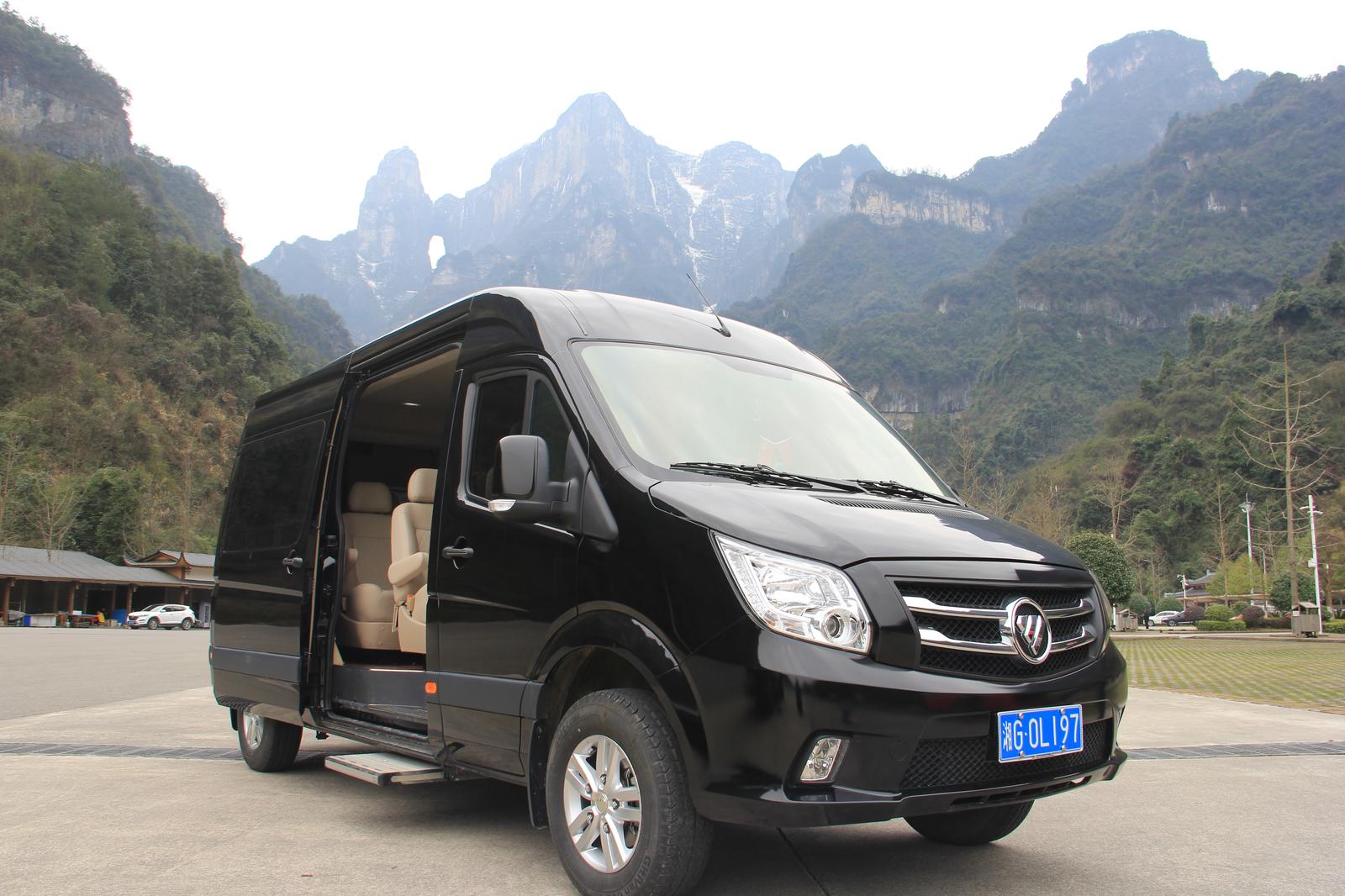 Our black passenger van with the side door open, parked below Tianmen Mountain, Zhangjiajie