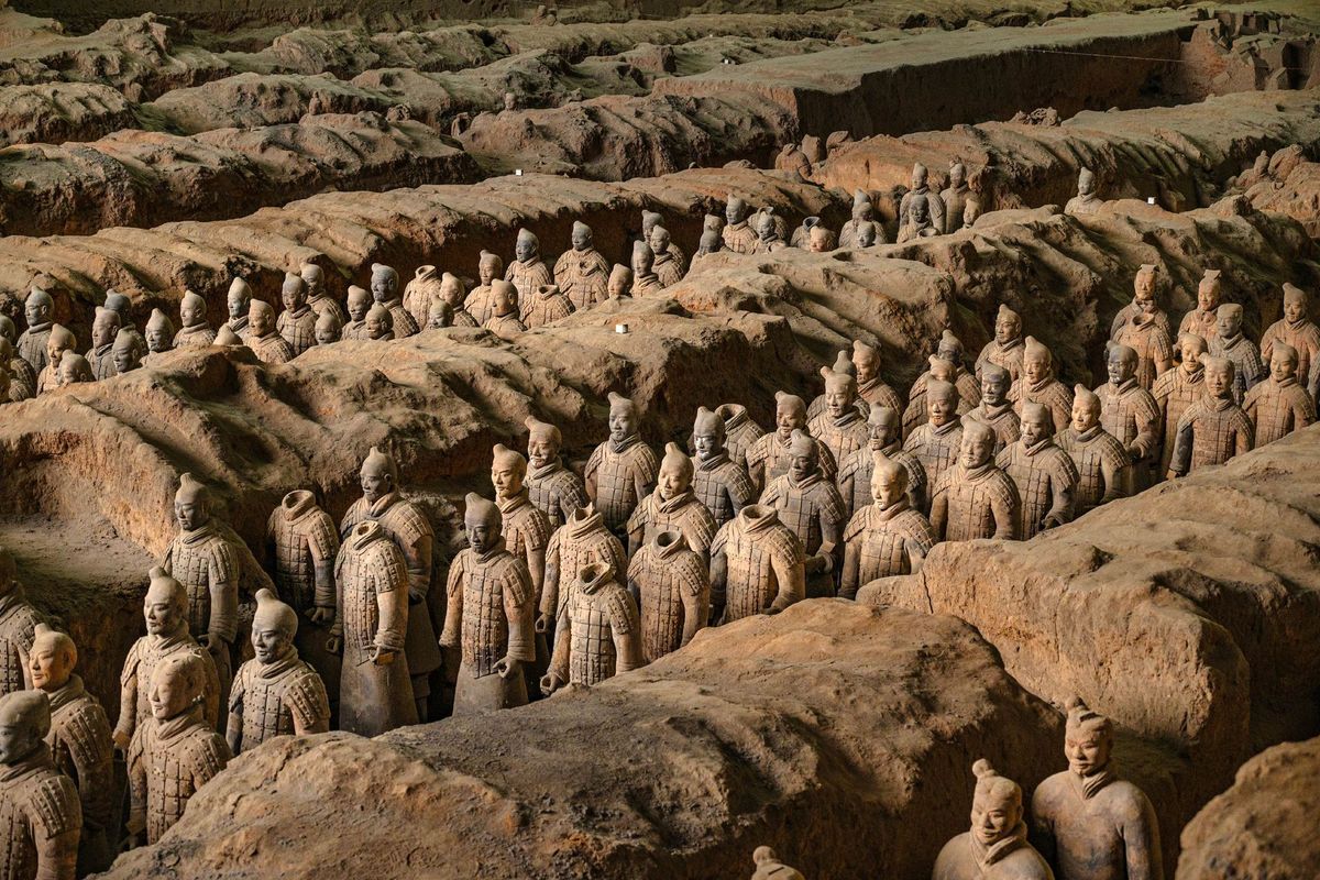 Rows of terracotta warriors standing in the earth corridors at the Terracotta Army museum, Xi'an
