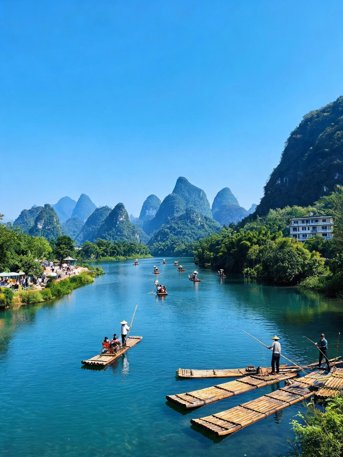 Bamboo rafts poled along a clear green river between karst peaks near Yangshuo, Guilin